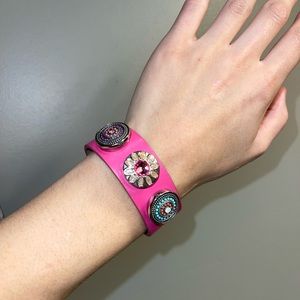 Leather pink bracelet with snap ons charms included.